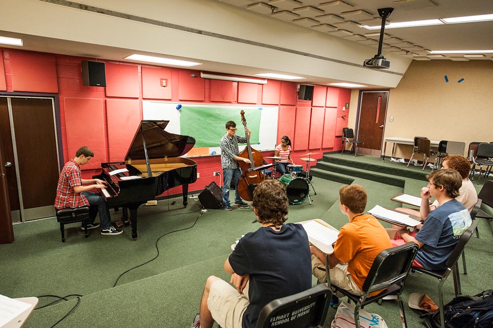 Summer camp students participate in piano class