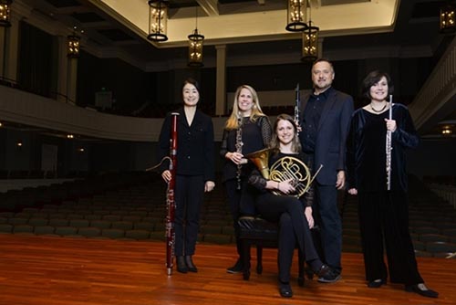 Woodwind Quintet posing on stage in McAfee concert hall