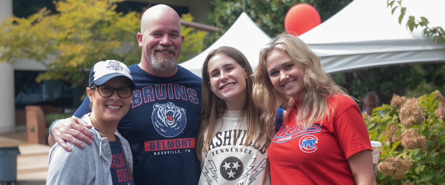 A family smiles for a photo at Parent & Family Weekend 2022.