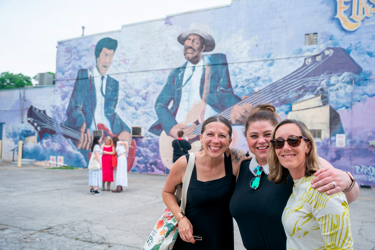Faculty and staff Ritchie, Bass and Pethel pose in front of a Jefferson St. mural