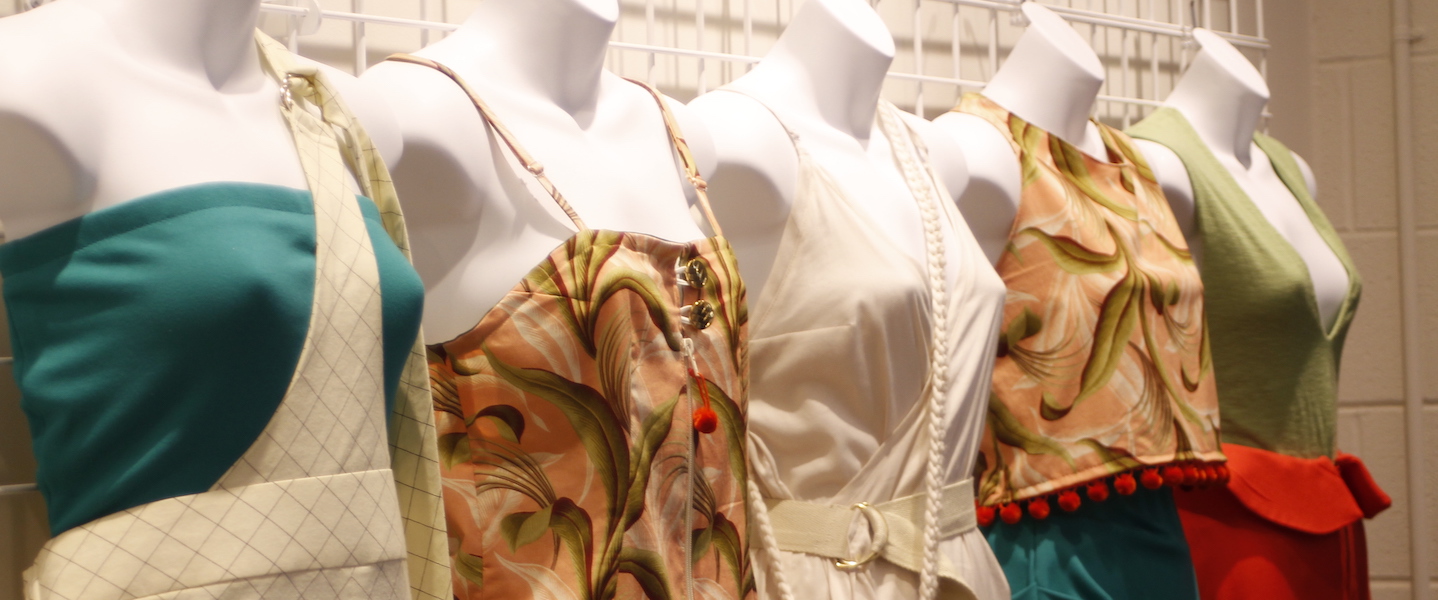 Four mannequins in a row with designs on them
