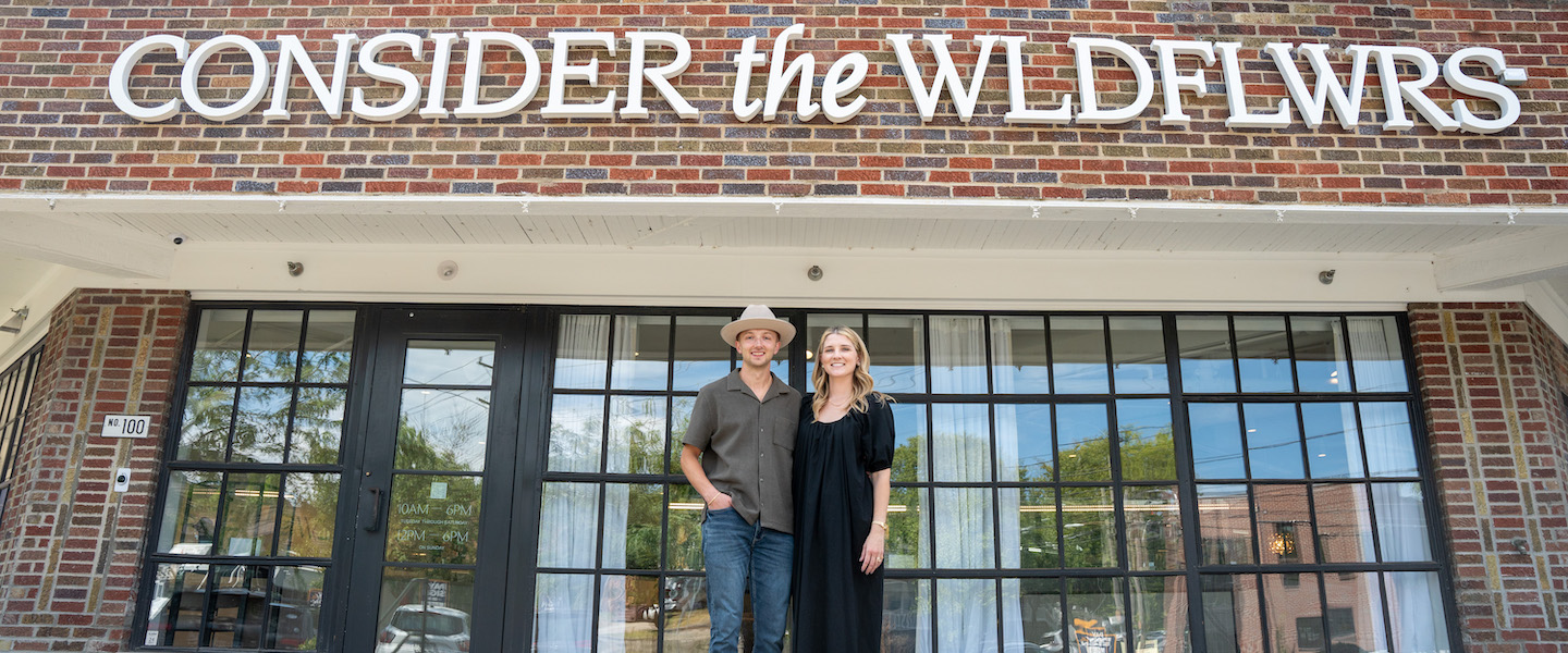 Emily and Ben in front of Consider the Wldflwrs store