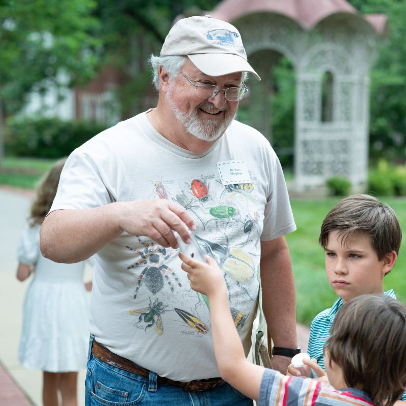 Dr. Steve Murphree smiles as he teaches students about bugs