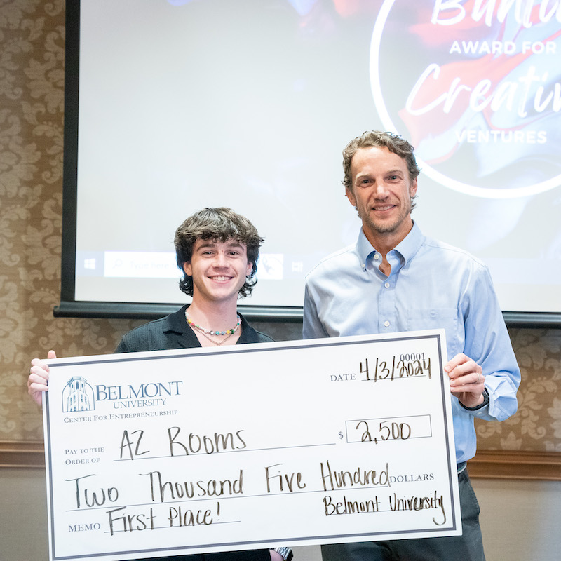 First place winner, Oliver Isenberg holds award check with Frazer Buntin