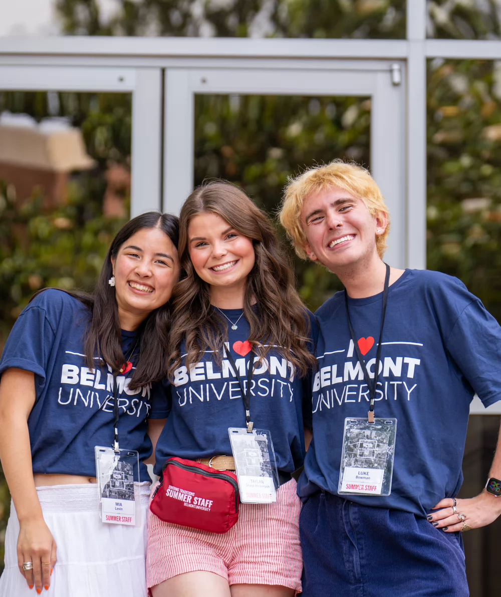Four students pose together in an embrace