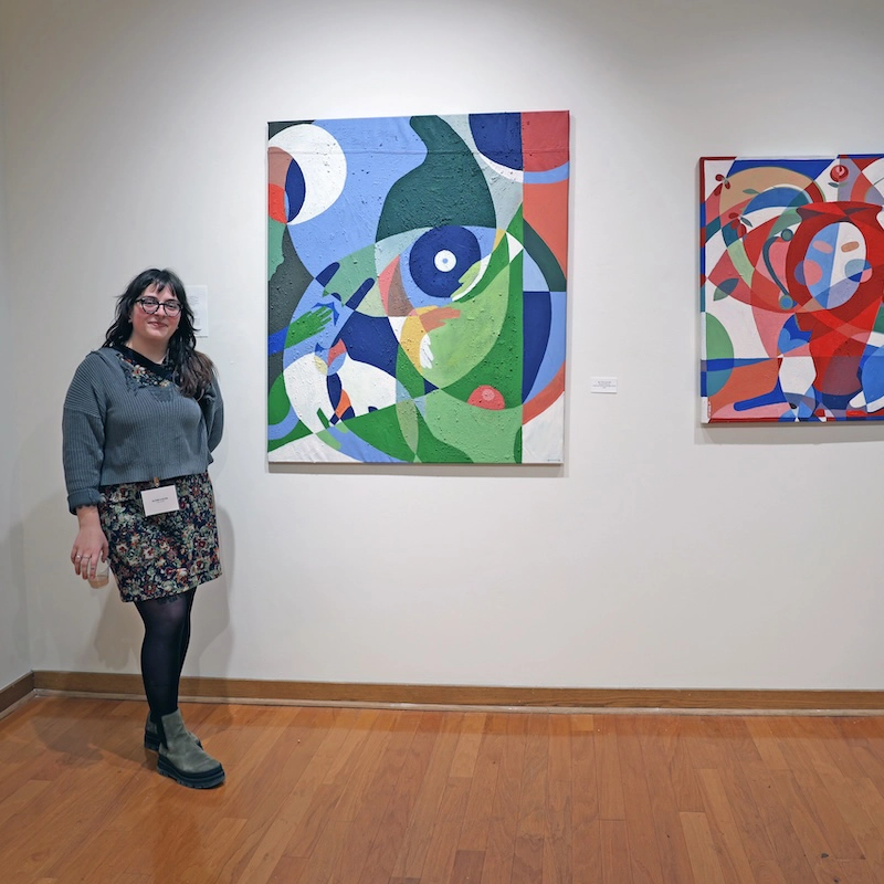 Colvin with her works in the exhibition.