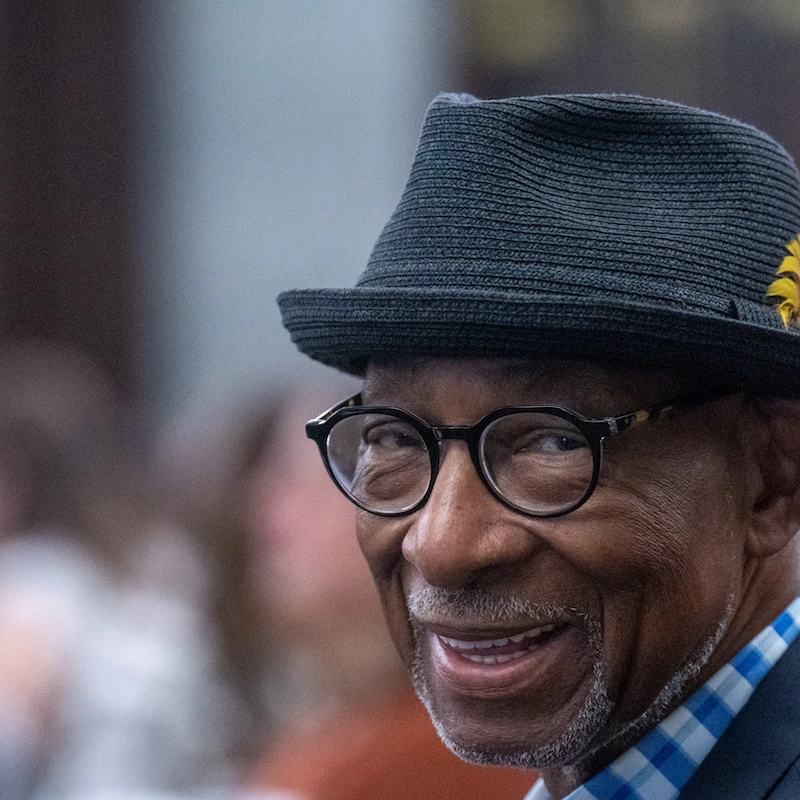 A close up photo of Lorenzo Washington wearing a tweed fedora.