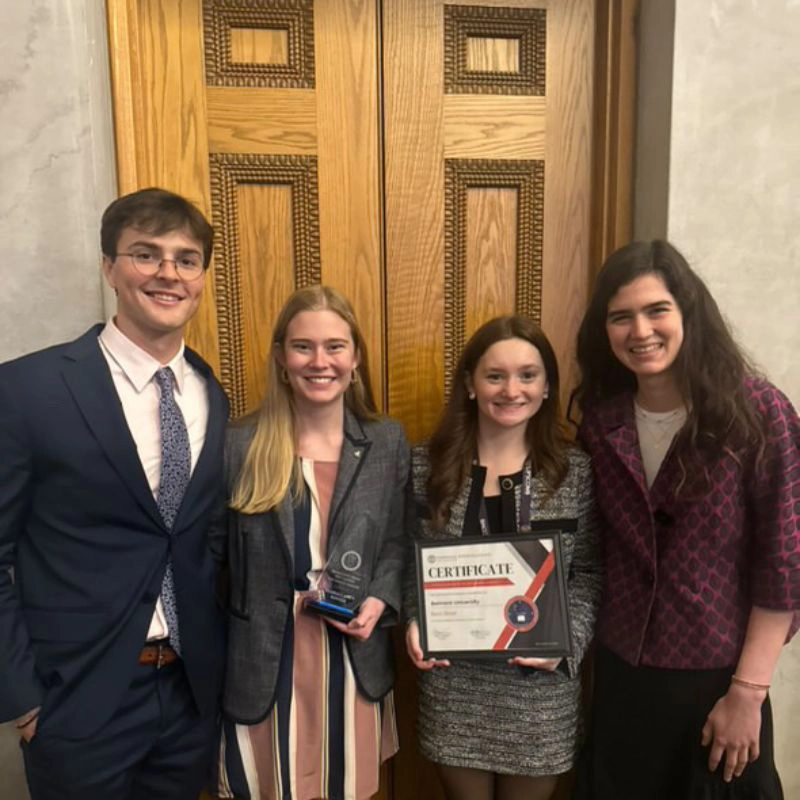 Four students pose with their awards at the TISL General Assembly