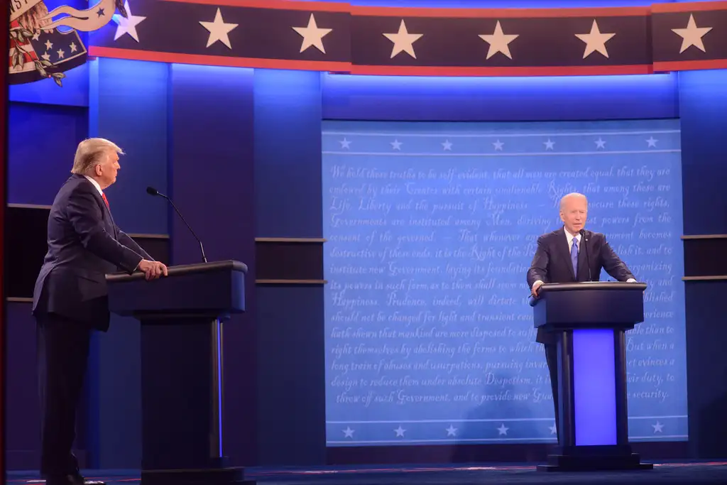An indoor photo of Donald Trump and Joe Biden each standing behind their lecterns during the 2020 Presidential Debates.