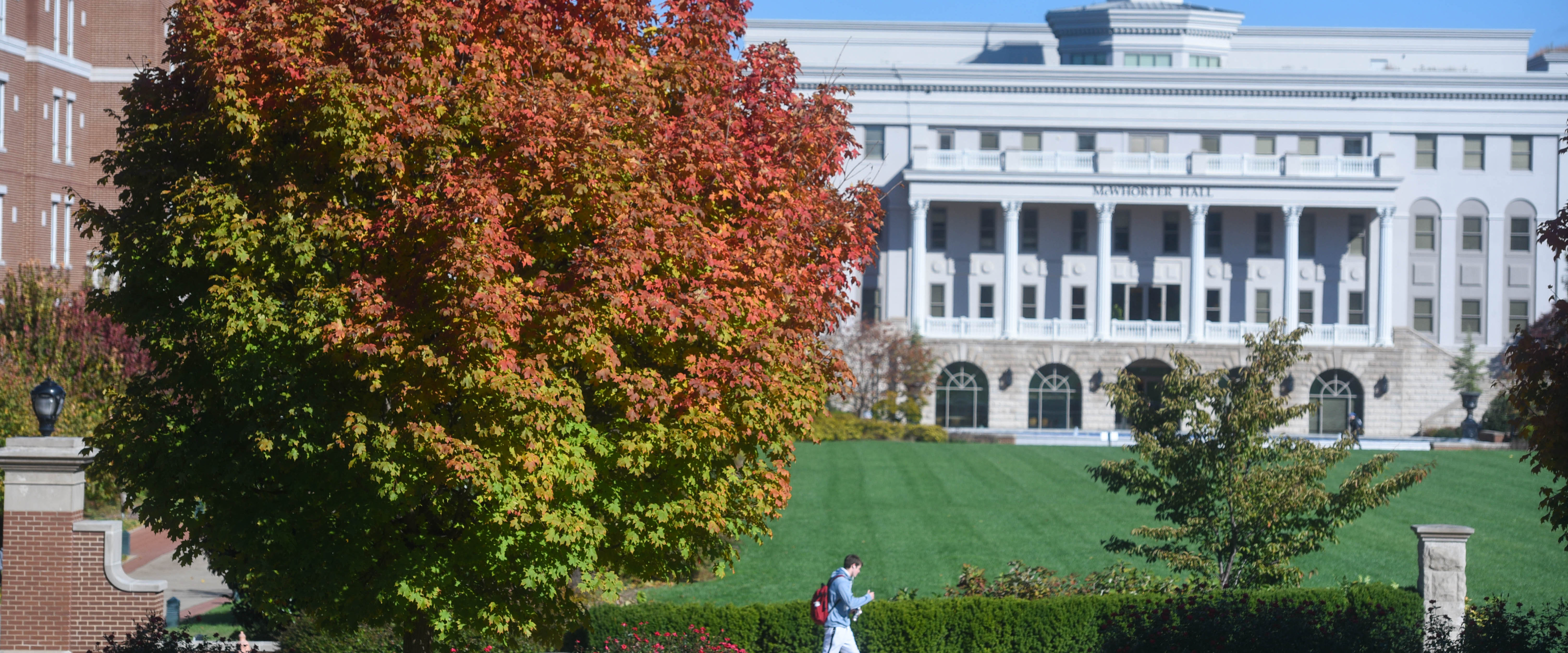 Student walking to class on a fall morning