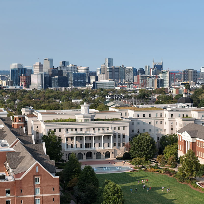 Aerial view of Belmont University's campus with the Nashville skyline in the background.