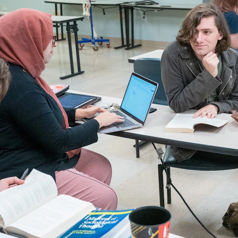 Students in class working on their laptops