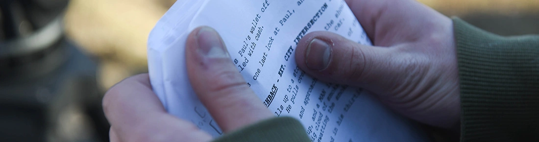 Hands holding a script