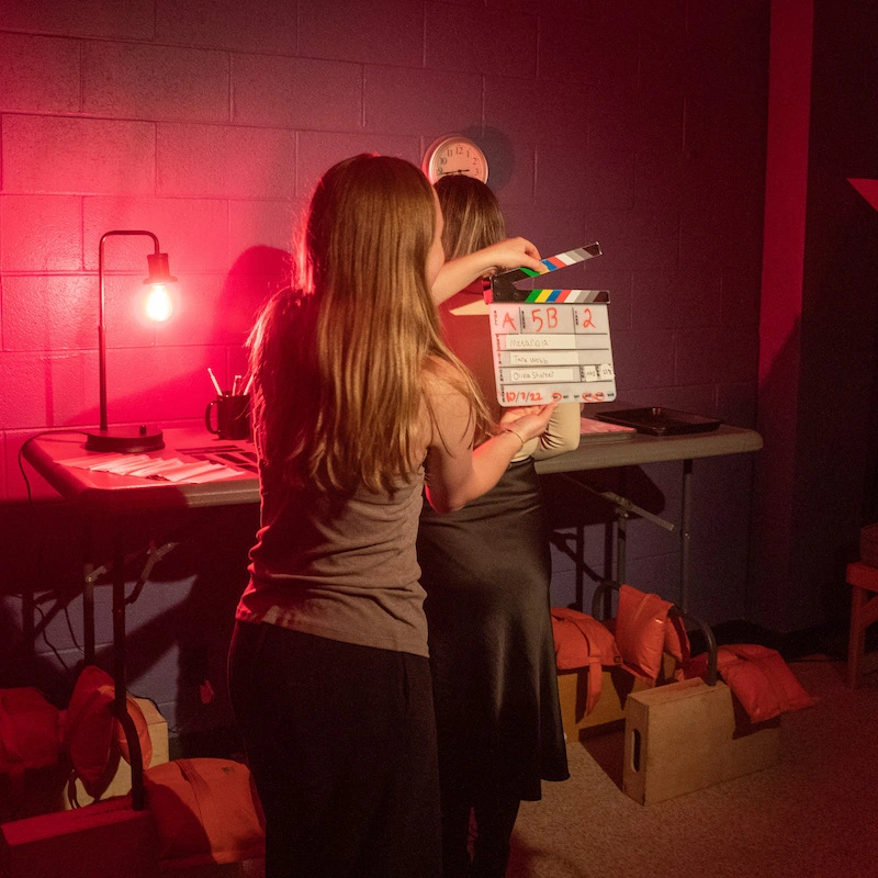 A student with a clacker between takes