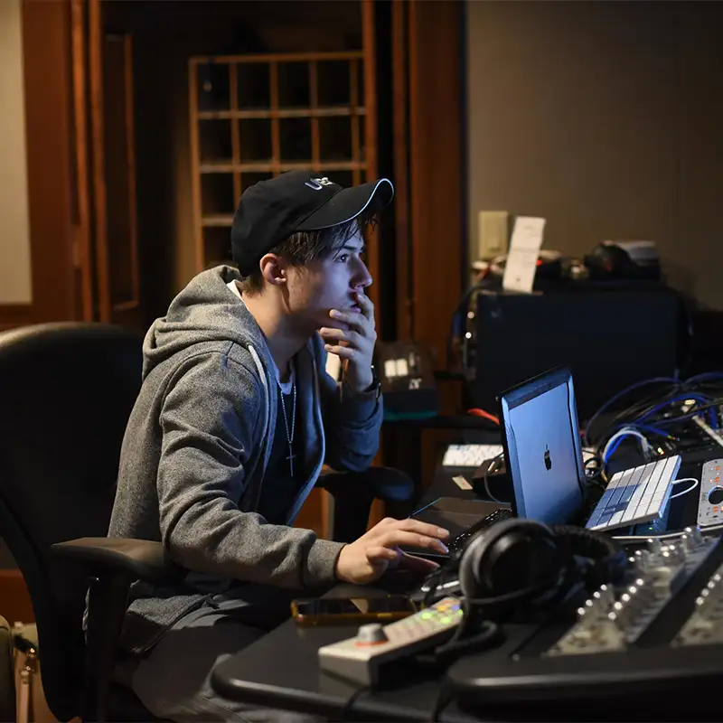 student at computer in studio. 