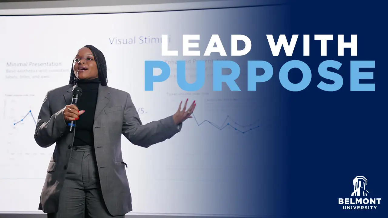 Speaker presenting with a microphone in front of a screen with charts, alongside the text “Lead with Purpose” and Belmont University logo.