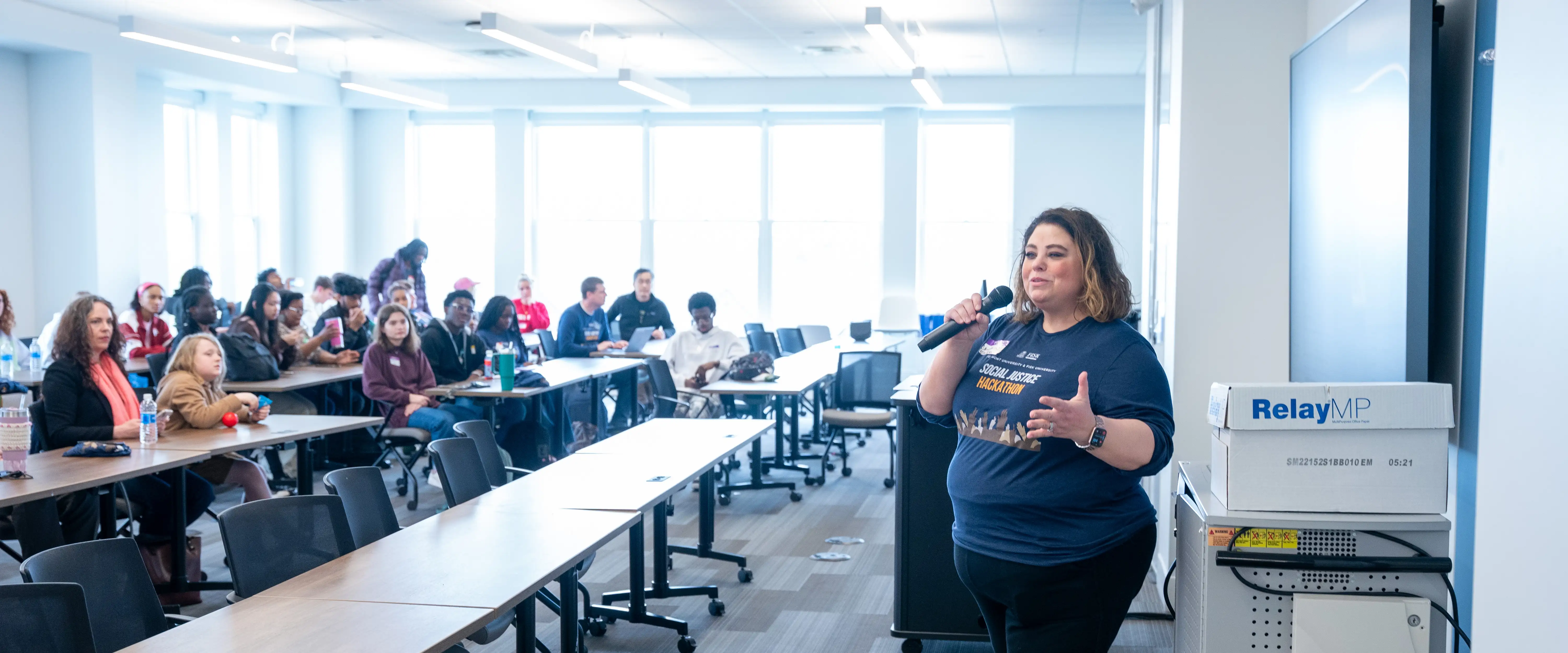 Presenter and audience at a hackathon workshop.