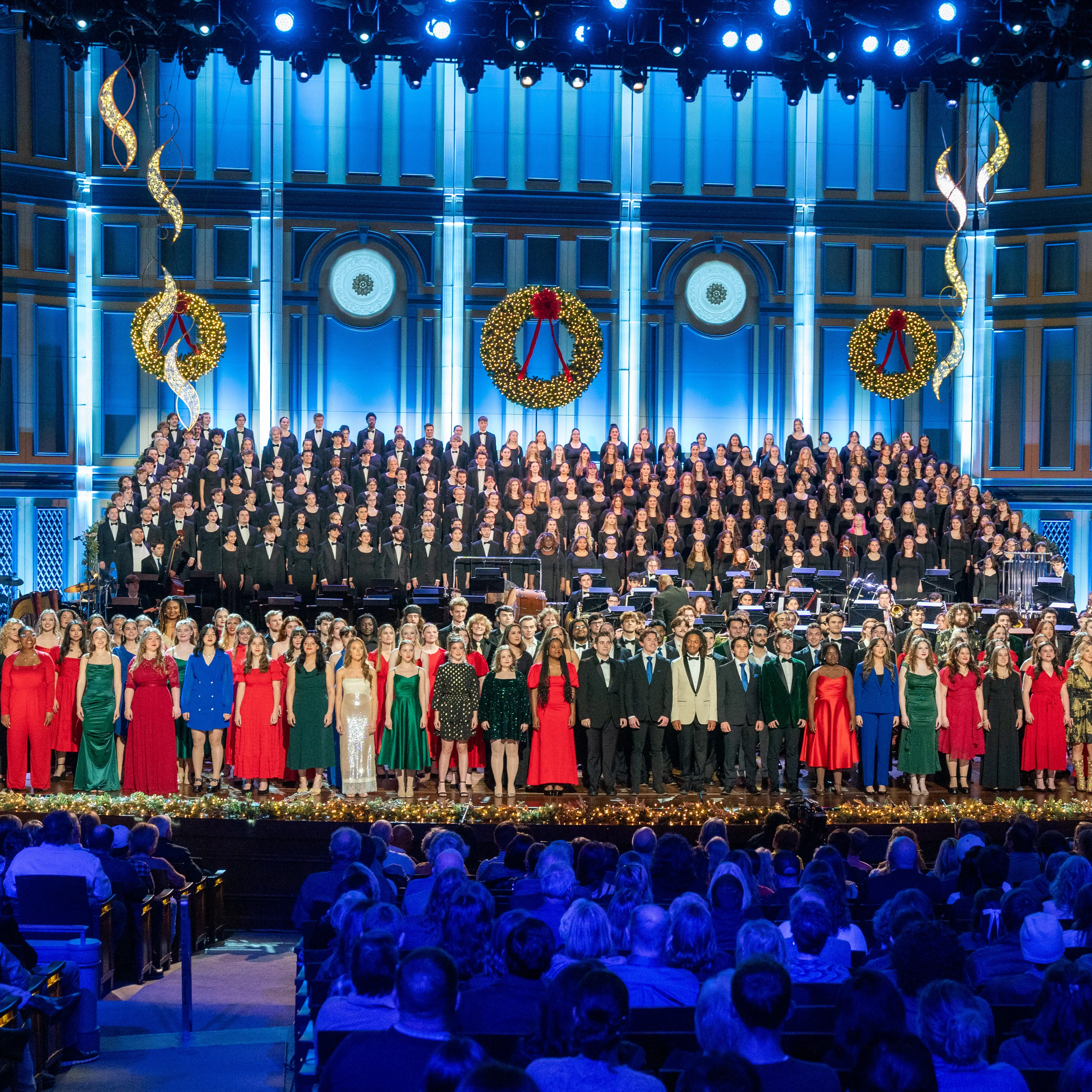 Students and choir members perform in Belmont University’s annual Christmas at Belmont concert at the Fisher Center for the Performing Arts, surrounded by festive wreaths, garlands and holiday lighting.