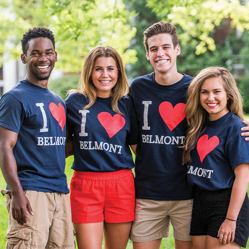 Four students posing for a photo together on Belmont's lawn wearing I love Belmont teeshirts