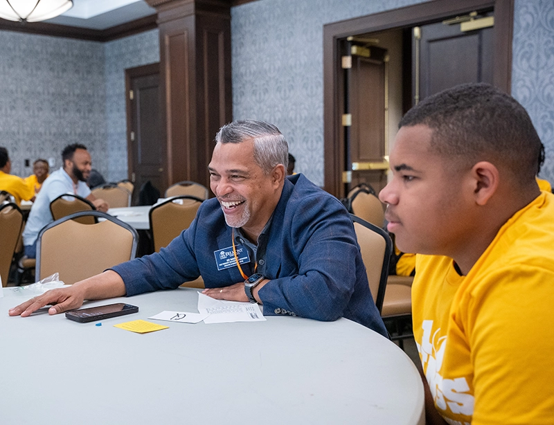 A Belmont employee smiling at a table with a group of children