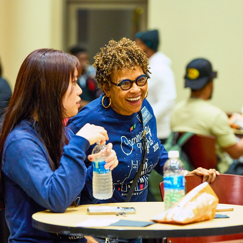 A Community Relations staff member laughs with a neighbor