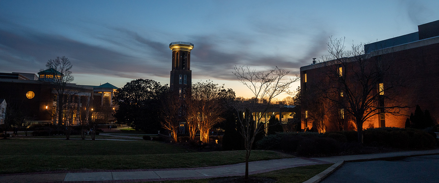 Belmont bell tower with the lights on at dusk