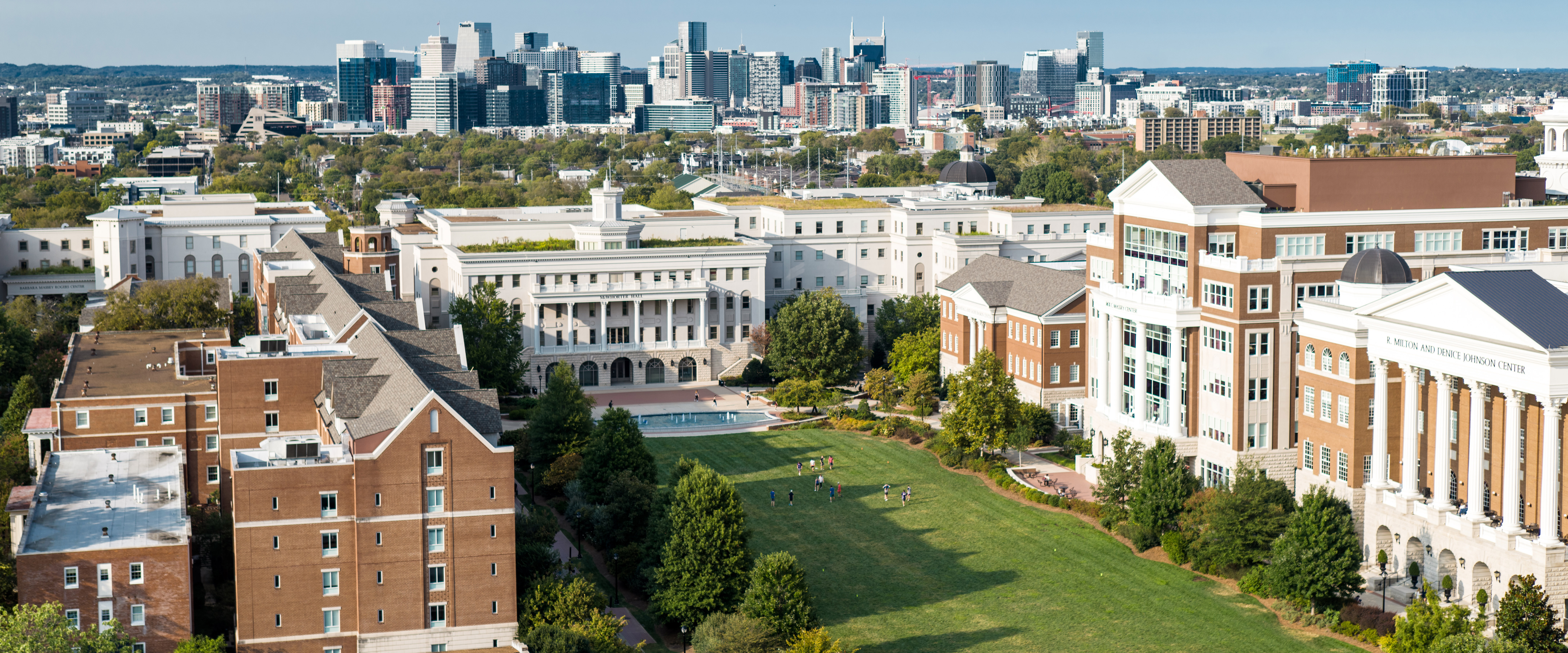 An aerial view of Belmont's main lawn with the Nashville skyline in the background.