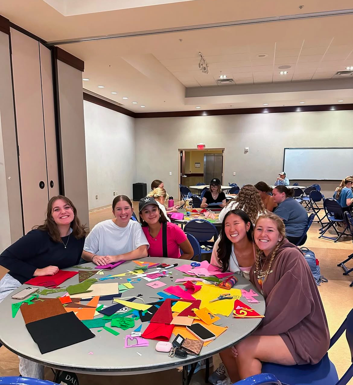 Group of panhellenic women sitting at craft table