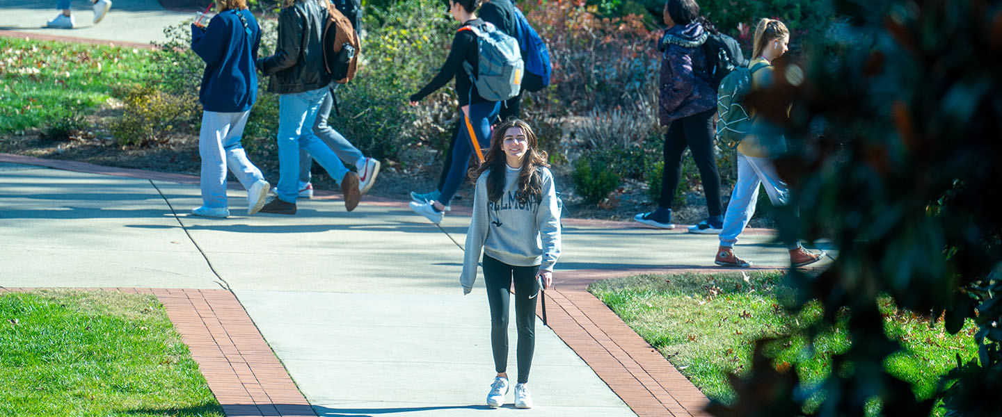 A student walking to class on the historic side of campus