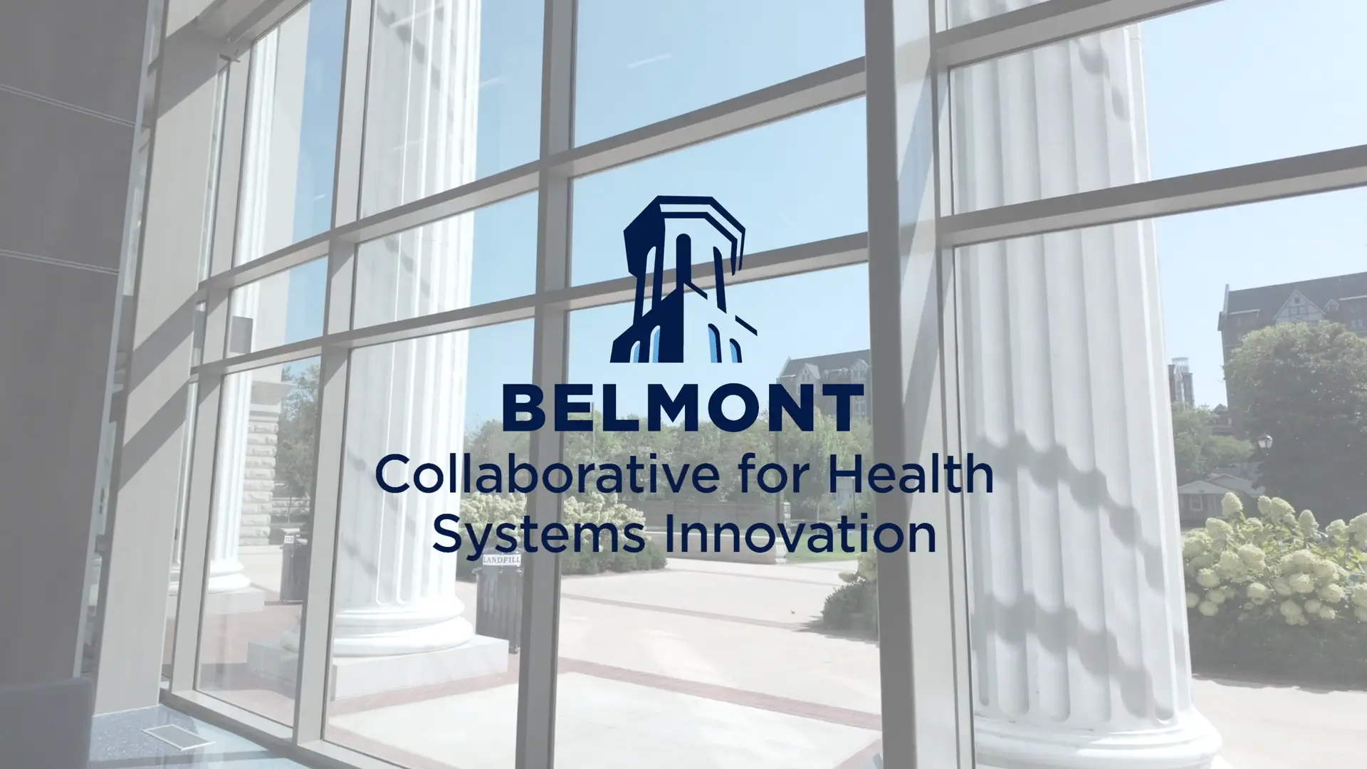 An indoor photo of two men seated and speaking at Symposium event