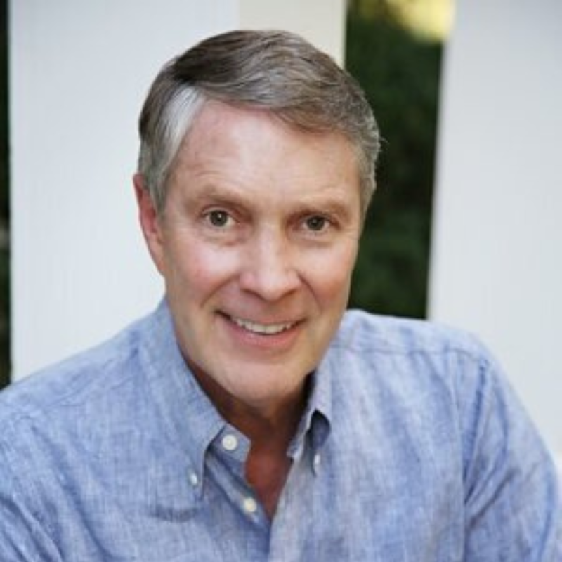 Headshot of Senator Bill Frist in a light blue button down shirt in front of a neutral background