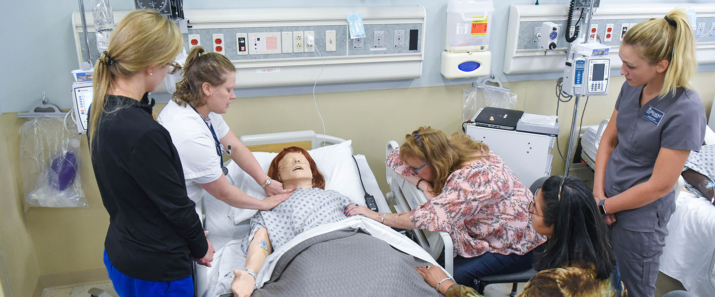 Health Science students work together in an end of life simulation