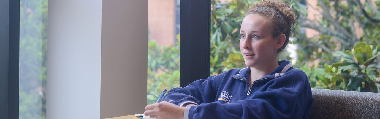 Student enjoying studying at Lila D. Bunch Library.