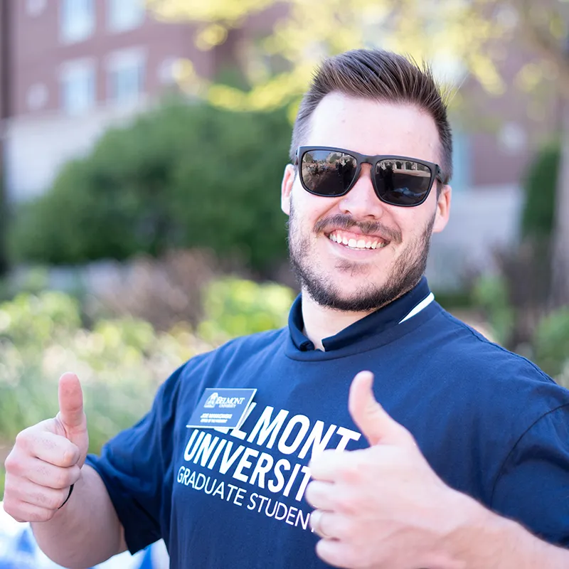 Graduate student giving two thumbs up