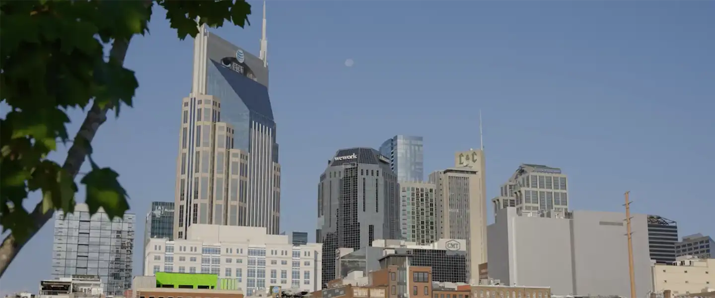 A view of downtown Nashville skyline featuring the AT&T “Batman” Building and surrounding high-rise buildings on a clear day.
