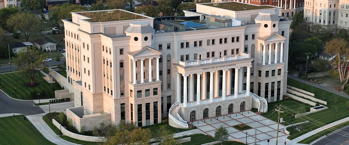 Aerial view of the Thomas F. Frist, Jr. College of Medicine building at Belmont University. The grand structure features classical architecture with tall white columns, stone accents, and symmetrical design elements.