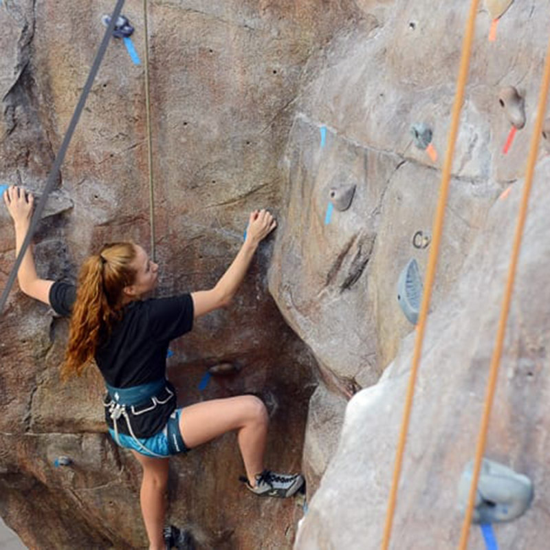 Girl rock climbing in the student life center