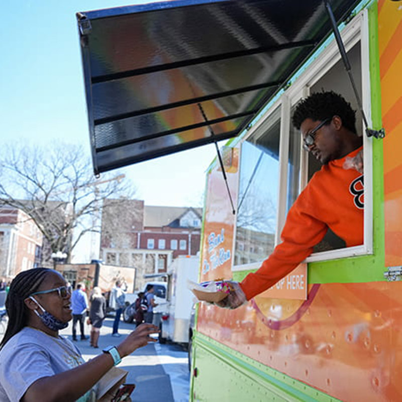 Student getting food from a food truck