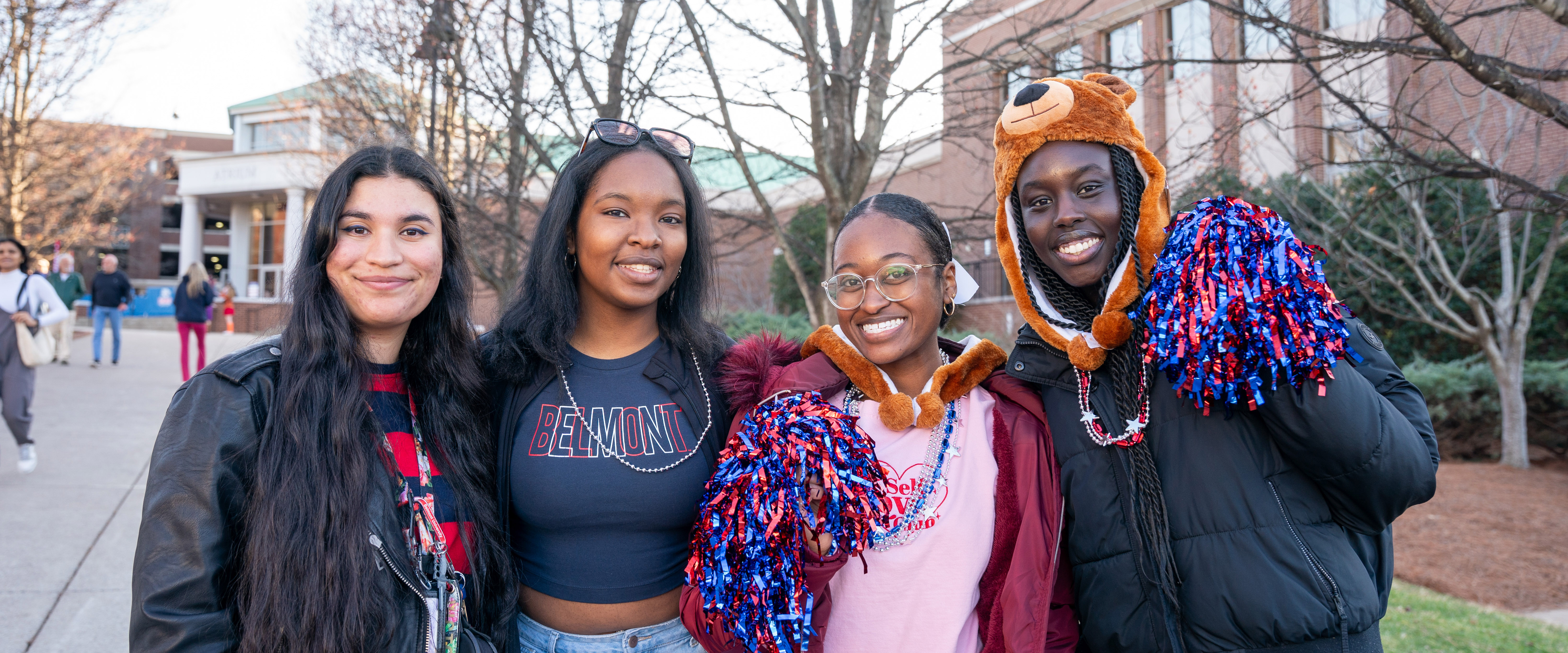 4 students smiling for the camera during homecoming parade