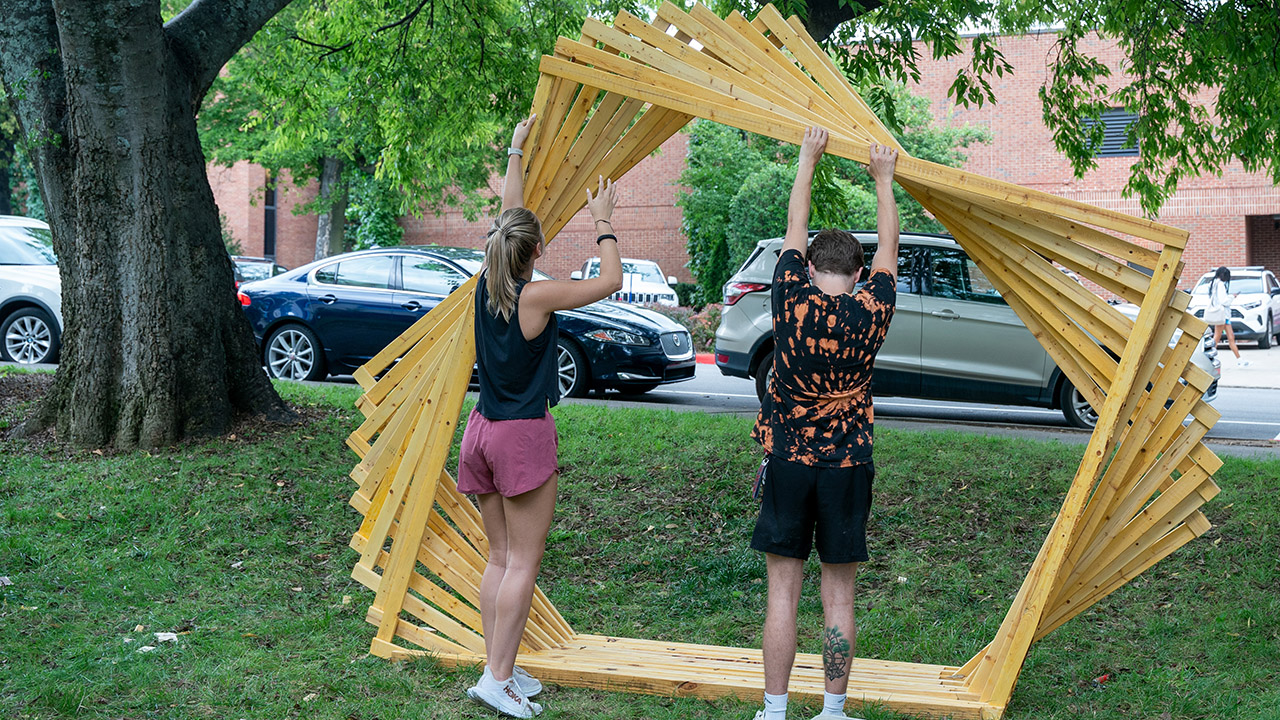 students work on the assembly of a real-world-sized pavilion made out of wood