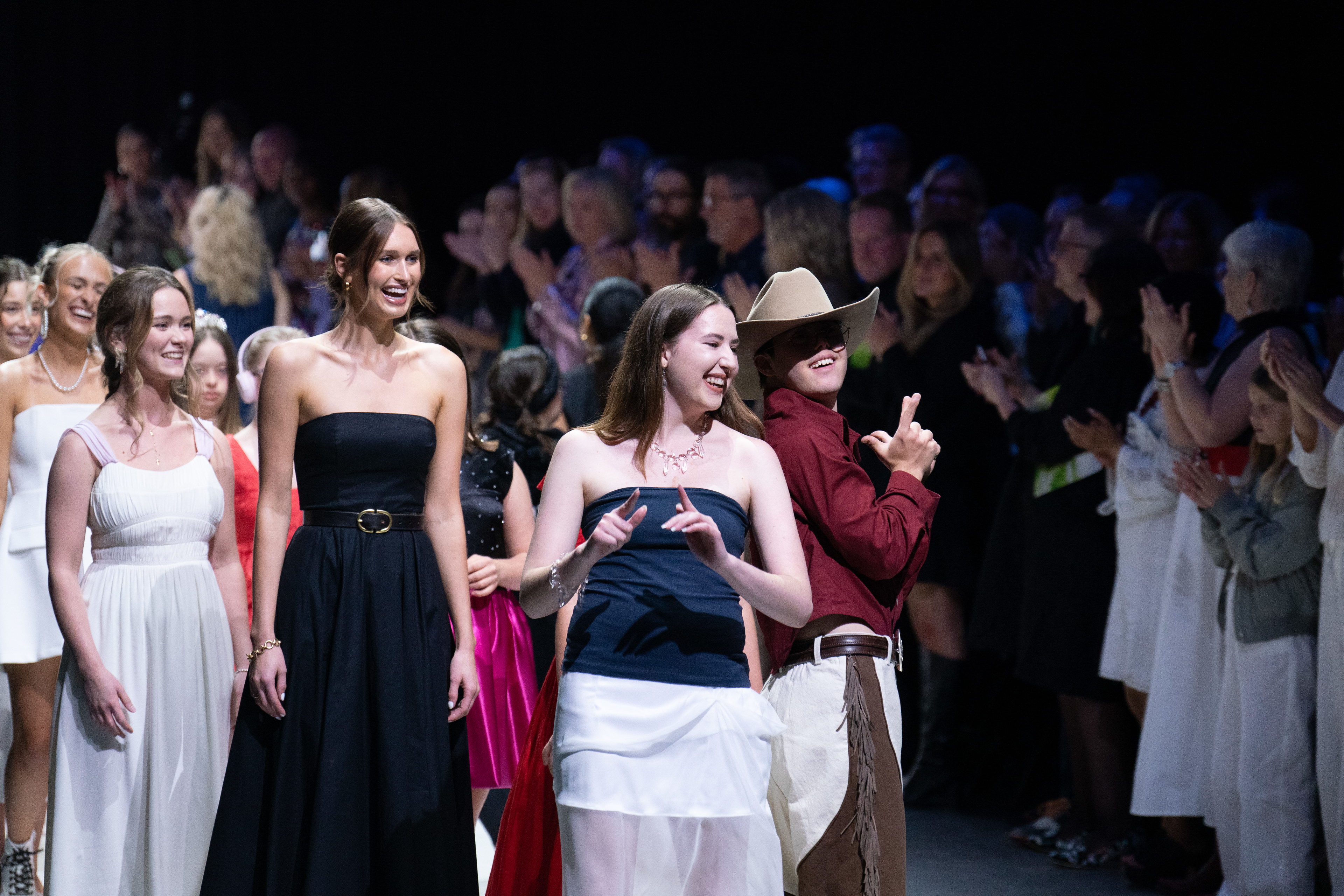 Fashion design student shows off model and design during fashion show