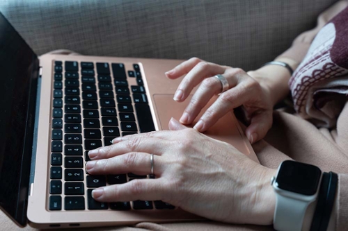 Hands typing at a keyboard