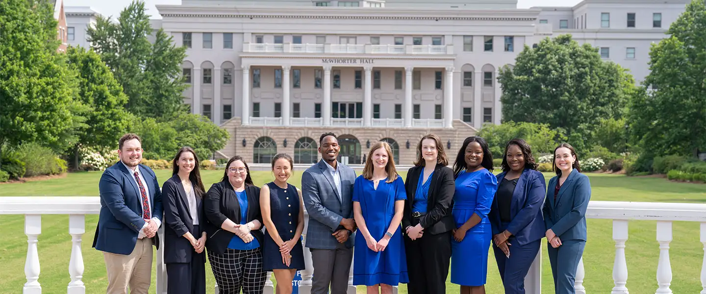 Pharmacy Fellows pose for a photo outside in front of a Belmont university fountain.