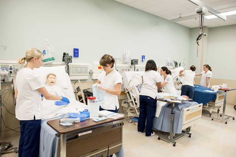 Graduate students in simulation lab