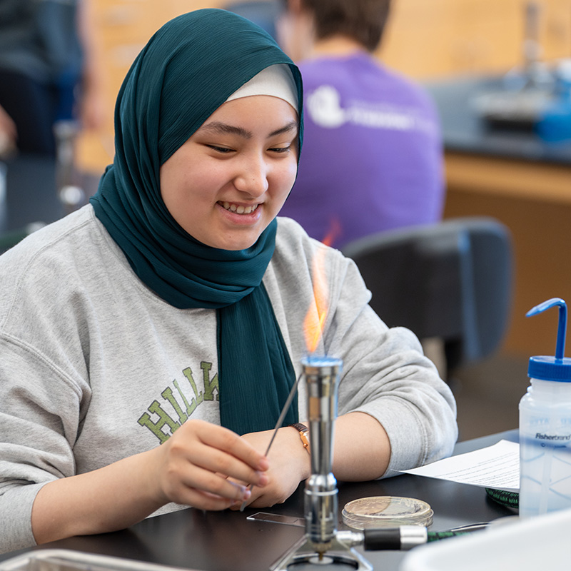 Student using bunsen burner in class during lad