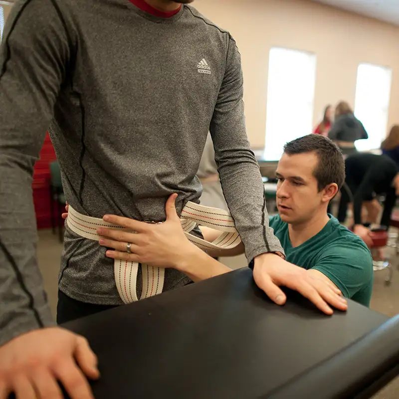 Student doing a hands on Physical Therapy lab