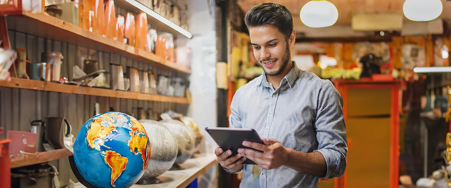 a person on an iPad at a small local business smiling