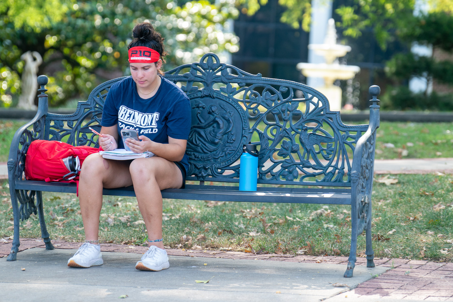 Sabrina Oostburg studying on a bench on campus.