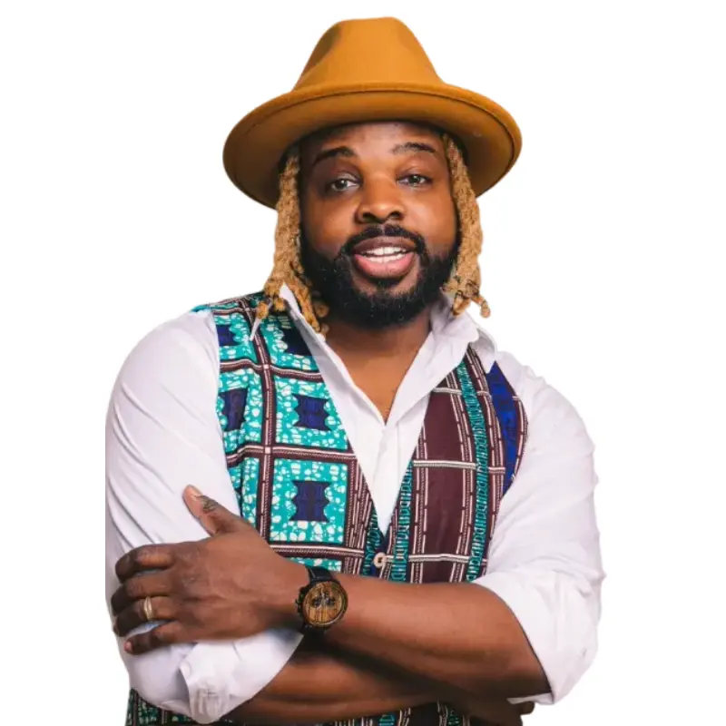 Fyutch dressed in a white button down, patterned vest, and a brown hat