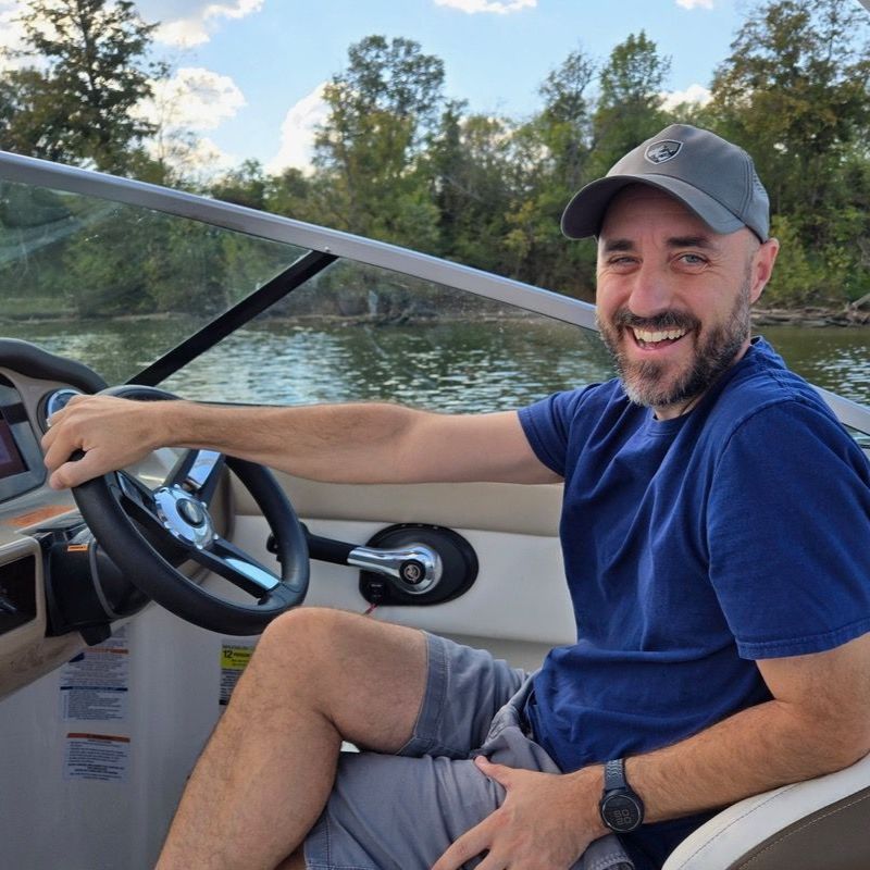 Dr. Matthew Heard on a boat during a research trip